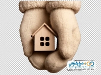 عکس با کیفیت خانه چوبی در دست با دستکش